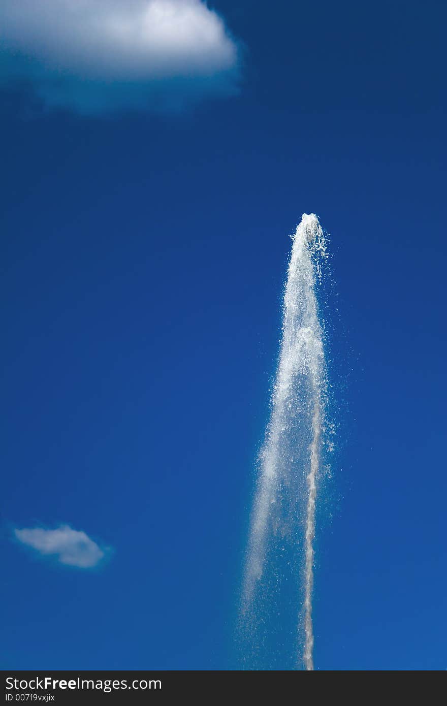 Fountain on a background of the sky and a cloud. Fountain on a background of the sky and a cloud