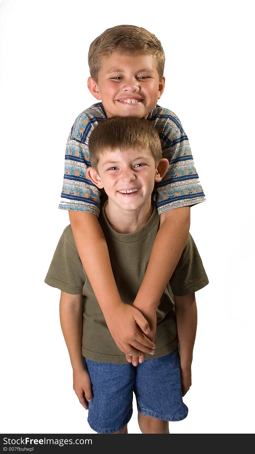 Big and little brother standing smiling isolated on a white background. Big and little brother standing smiling isolated on a white background.