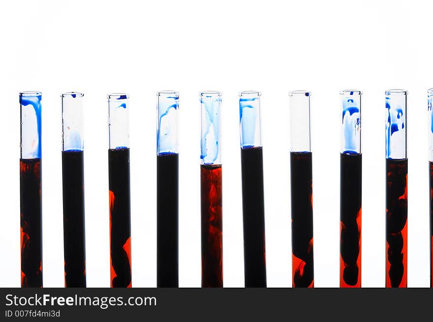 Glass test tubes standing in a line filled with strange black-orange liquid. Glass test tubes standing in a line filled with strange black-orange liquid