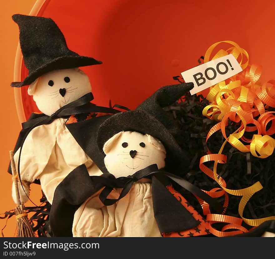 2 small cat dolls dressed as witches with black raffia, ribbon and a boo sign. 2 small cat dolls dressed as witches with black raffia, ribbon and a boo sign