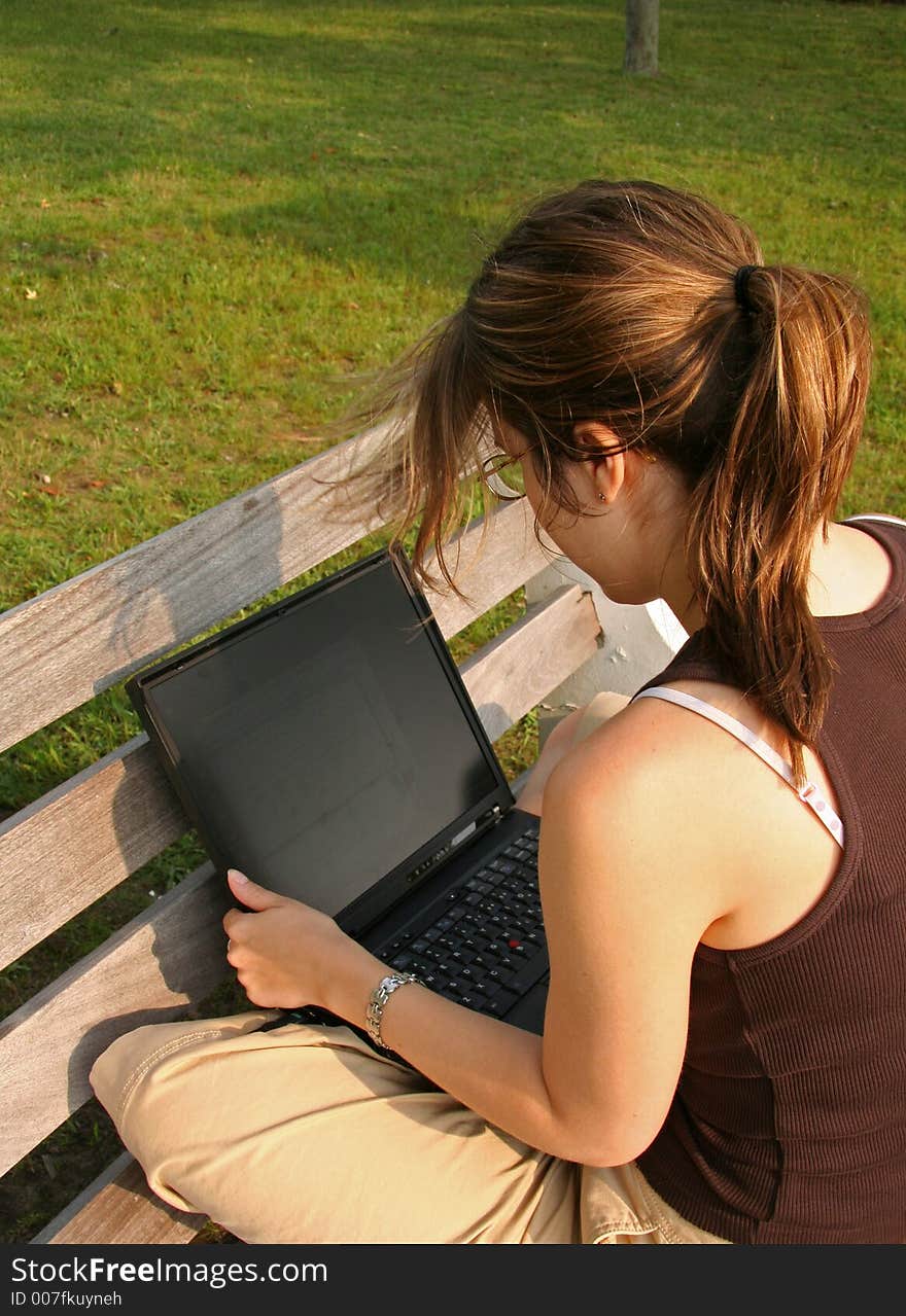 Student working on laptop in the Park