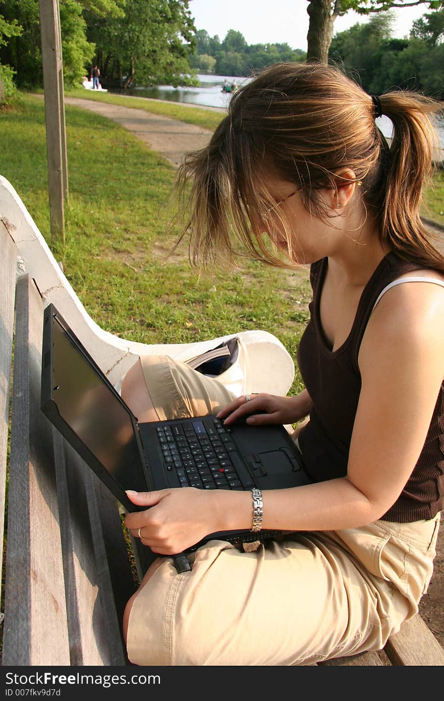 Student working on laptop in the Park