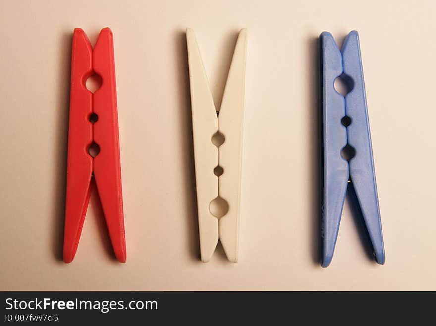 Three clothes pegs