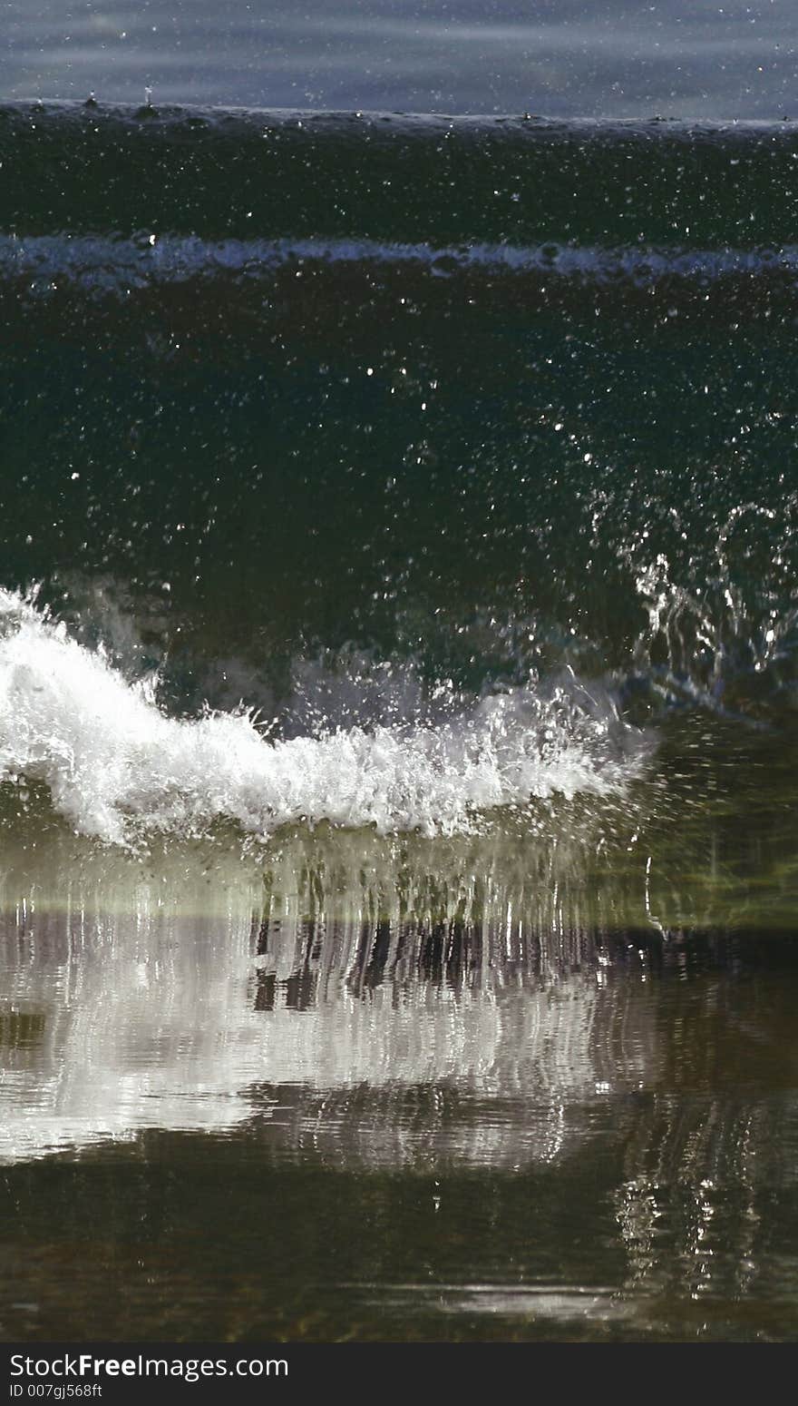 A wave breaking on the sand. A wave breaking on the sand