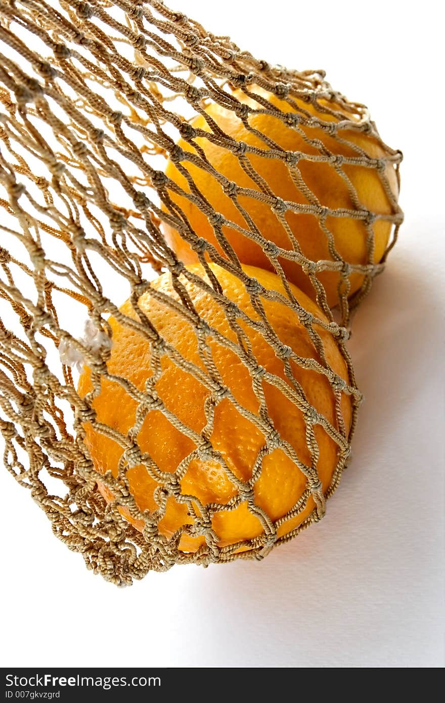 Two oranges in vintage string-bag. Two oranges in vintage string-bag