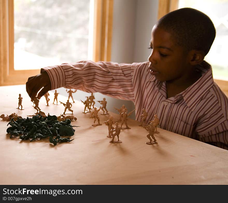 Young boy planning out strategy for war games. Young boy planning out strategy for war games