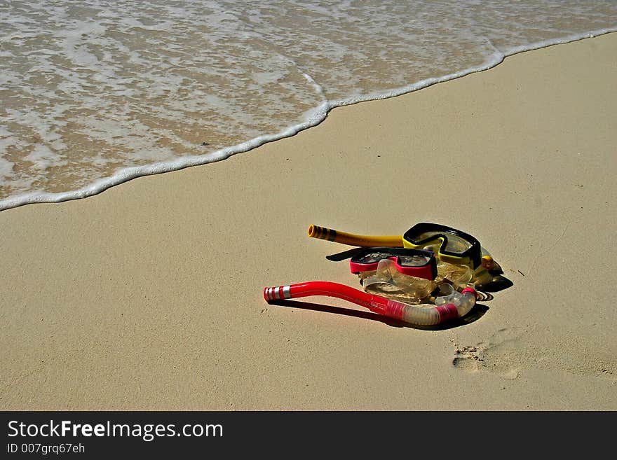 2 pairs of goggles on the beach