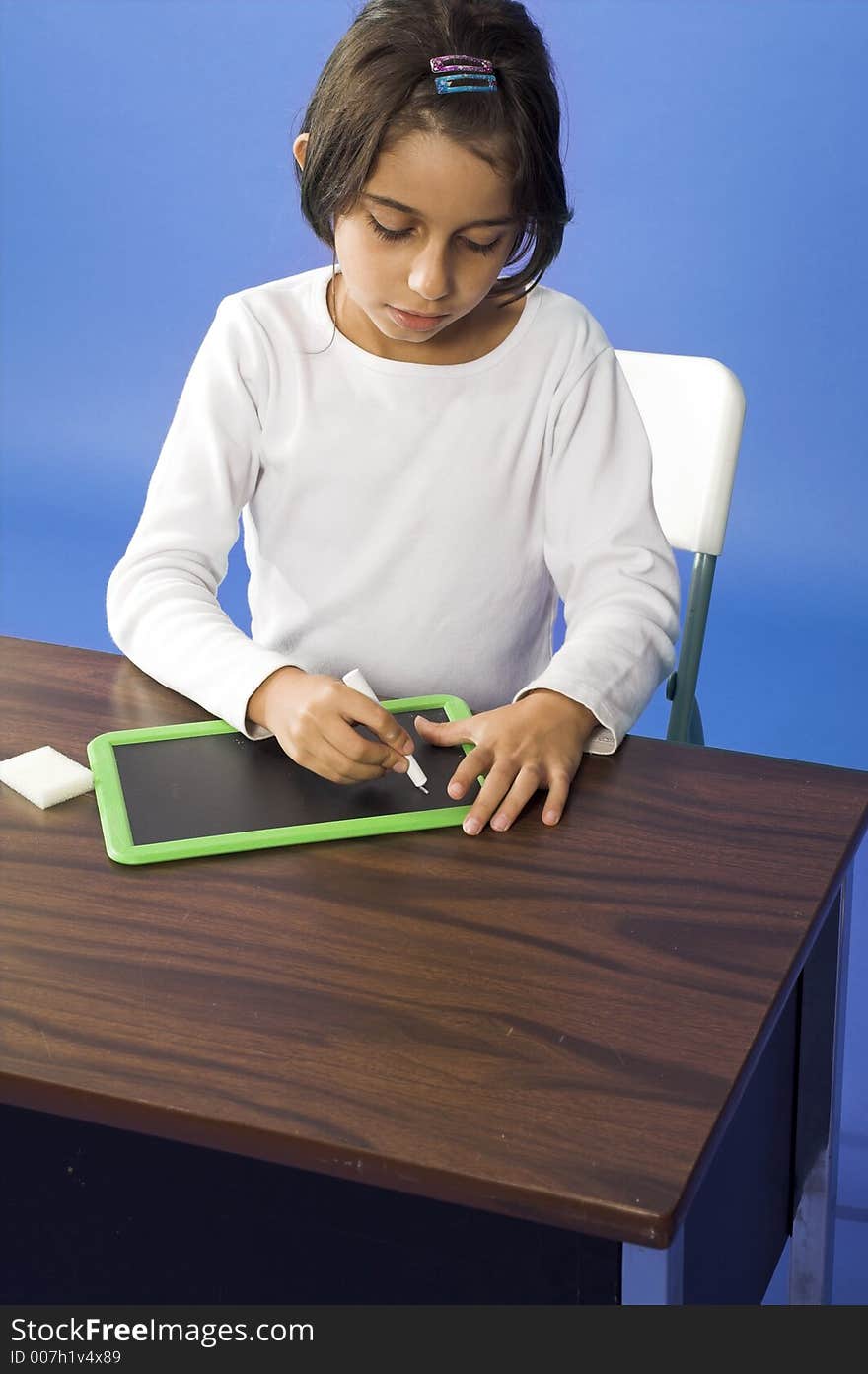 Little girl writing on board