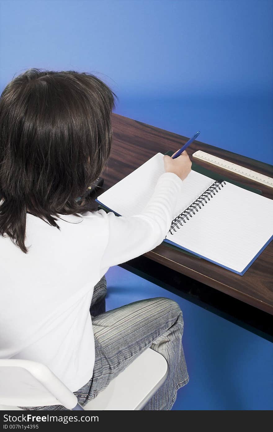 Little girl sitting on chair in classroom