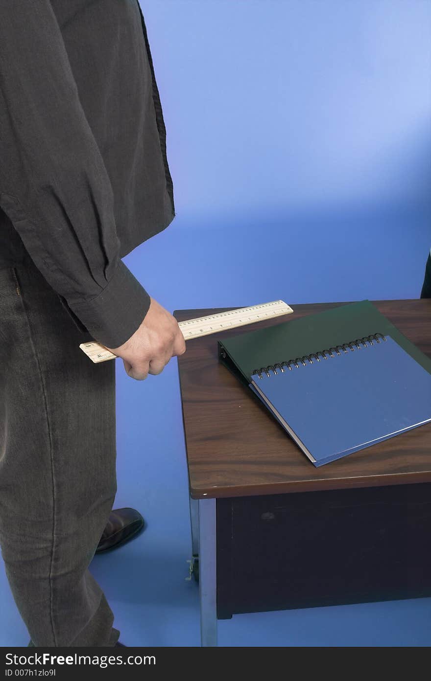 Teacher with ruler in classroom