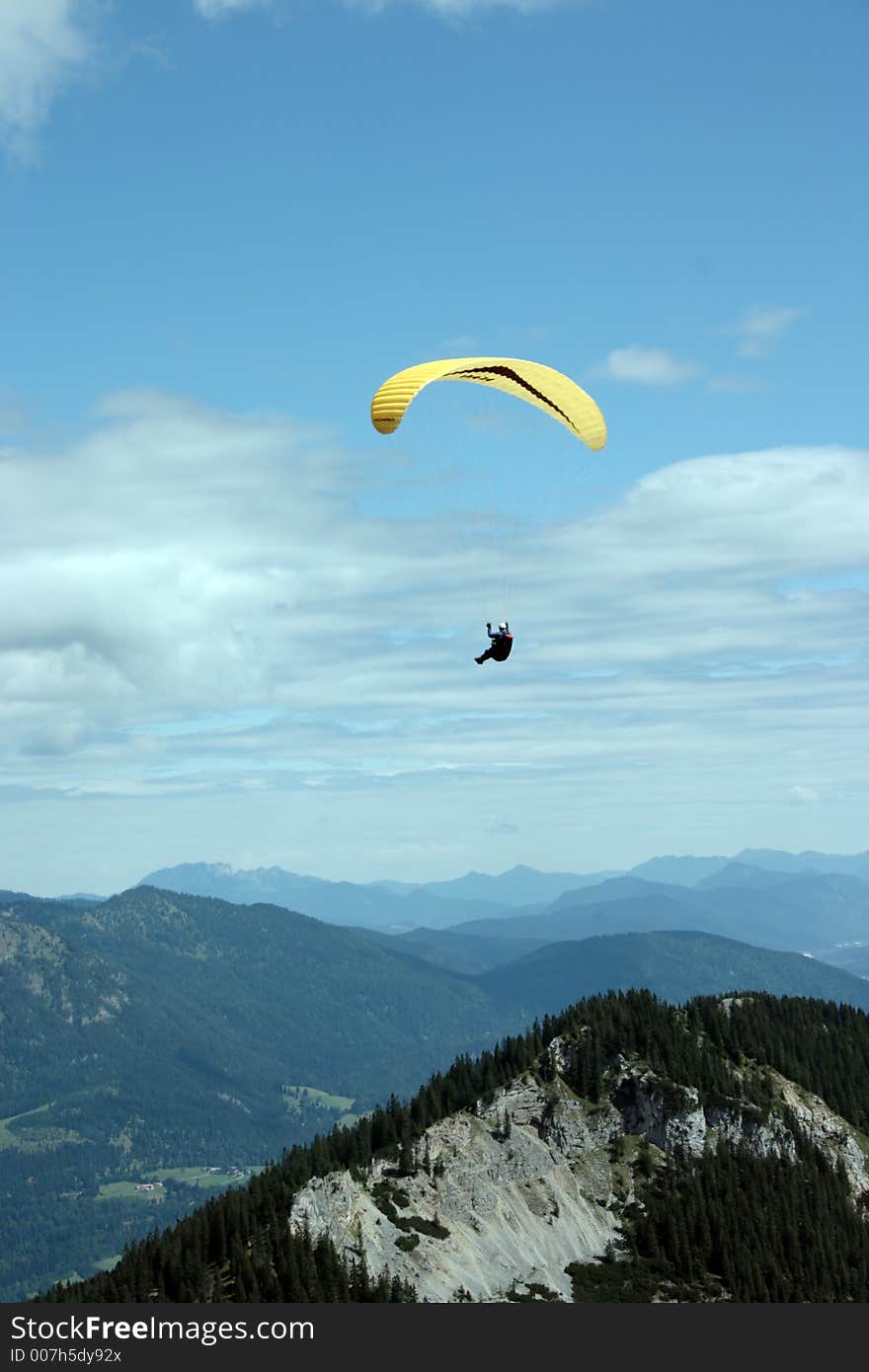 Paraglider flying high over mountains