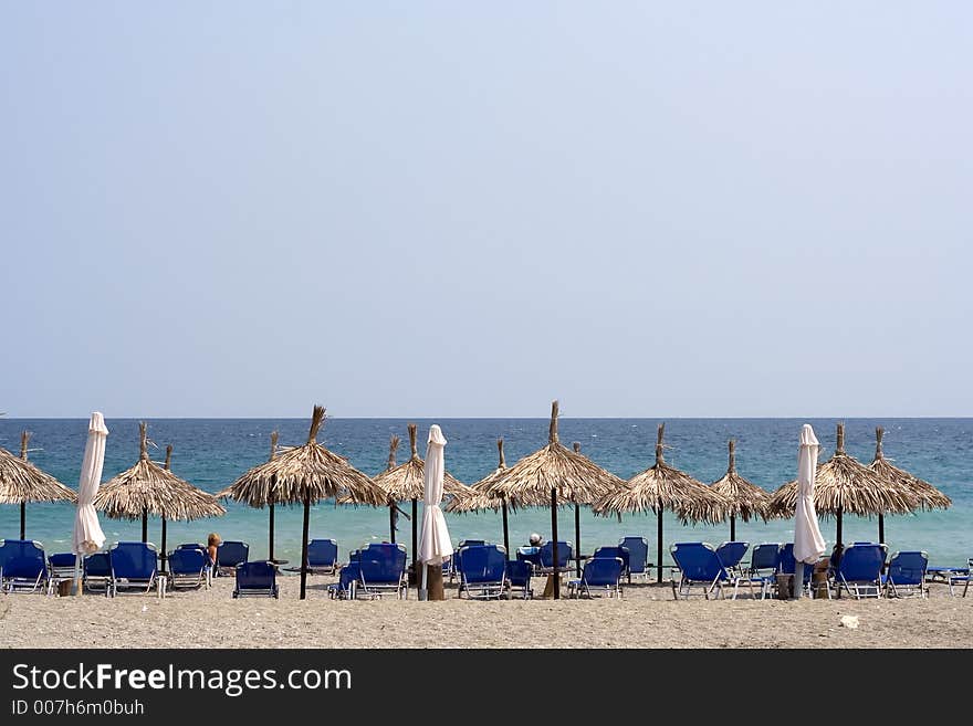 Umbrellas and beach chairs for relaxing by the sea. Umbrellas and beach chairs for relaxing by the sea