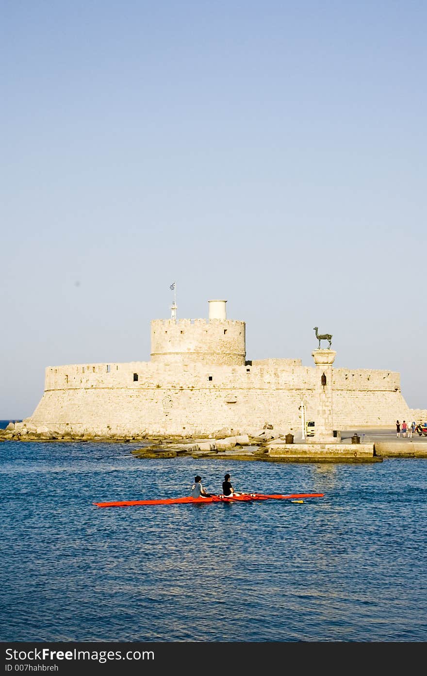 The port of Rhodes with the medieval walls, culum with the city symbol, a deer, and a canoe.