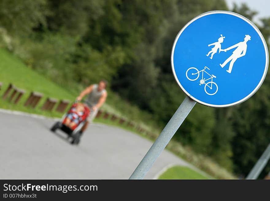 Man with baby-coach on bike trail