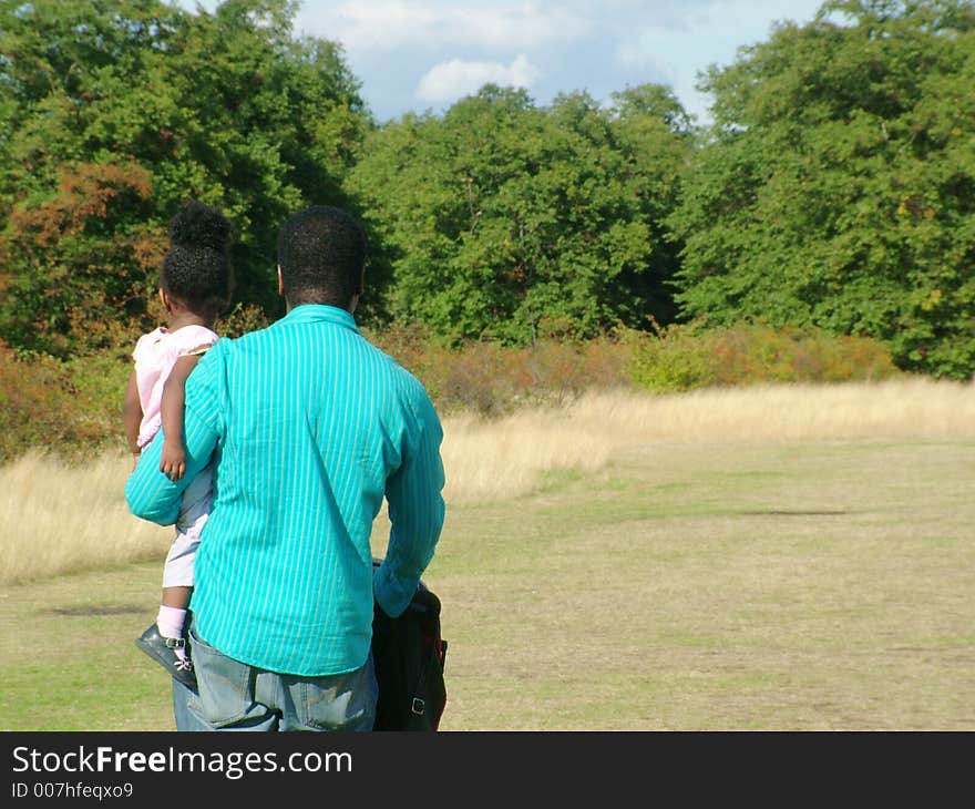 Male and baby walking through crountryside. Male and baby walking through crountryside