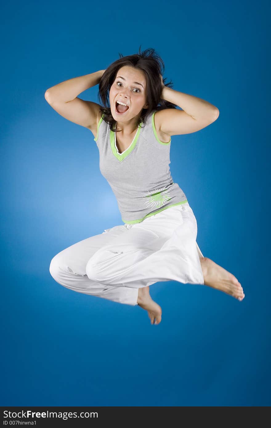 Jumping happy woman on the blue background