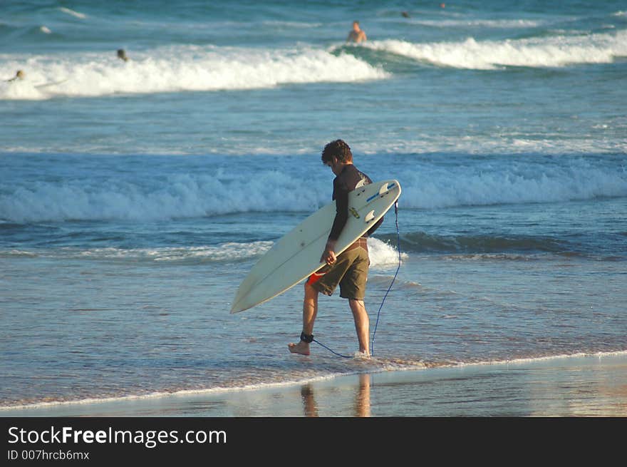 Man walking into the surf. Man walking into the surf