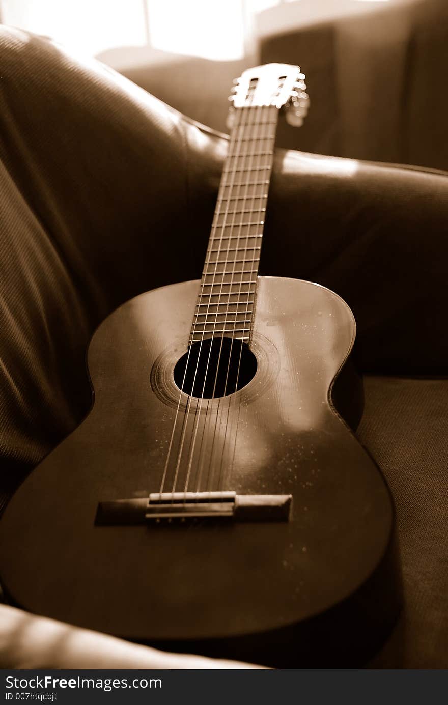 Six string acoustic guitar making little noise in the late-afternoon sunshine. Six string acoustic guitar making little noise in the late-afternoon sunshine