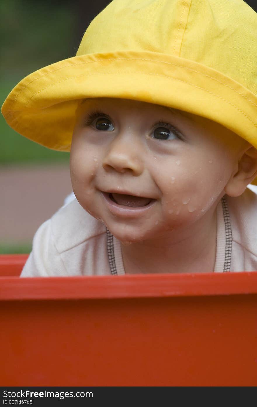 The waterbaby is wetting his face.