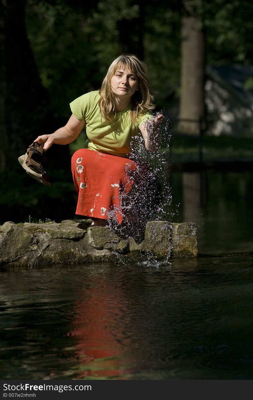 Woman is splashing a water. Woman is splashing a water.