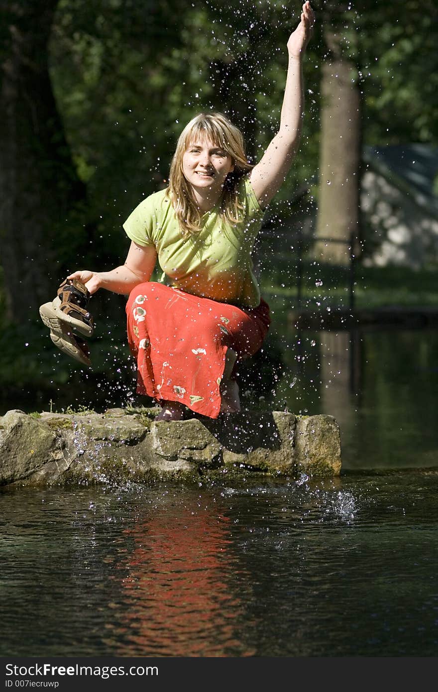 Woman is splashing a water. Woman is splashing a water.