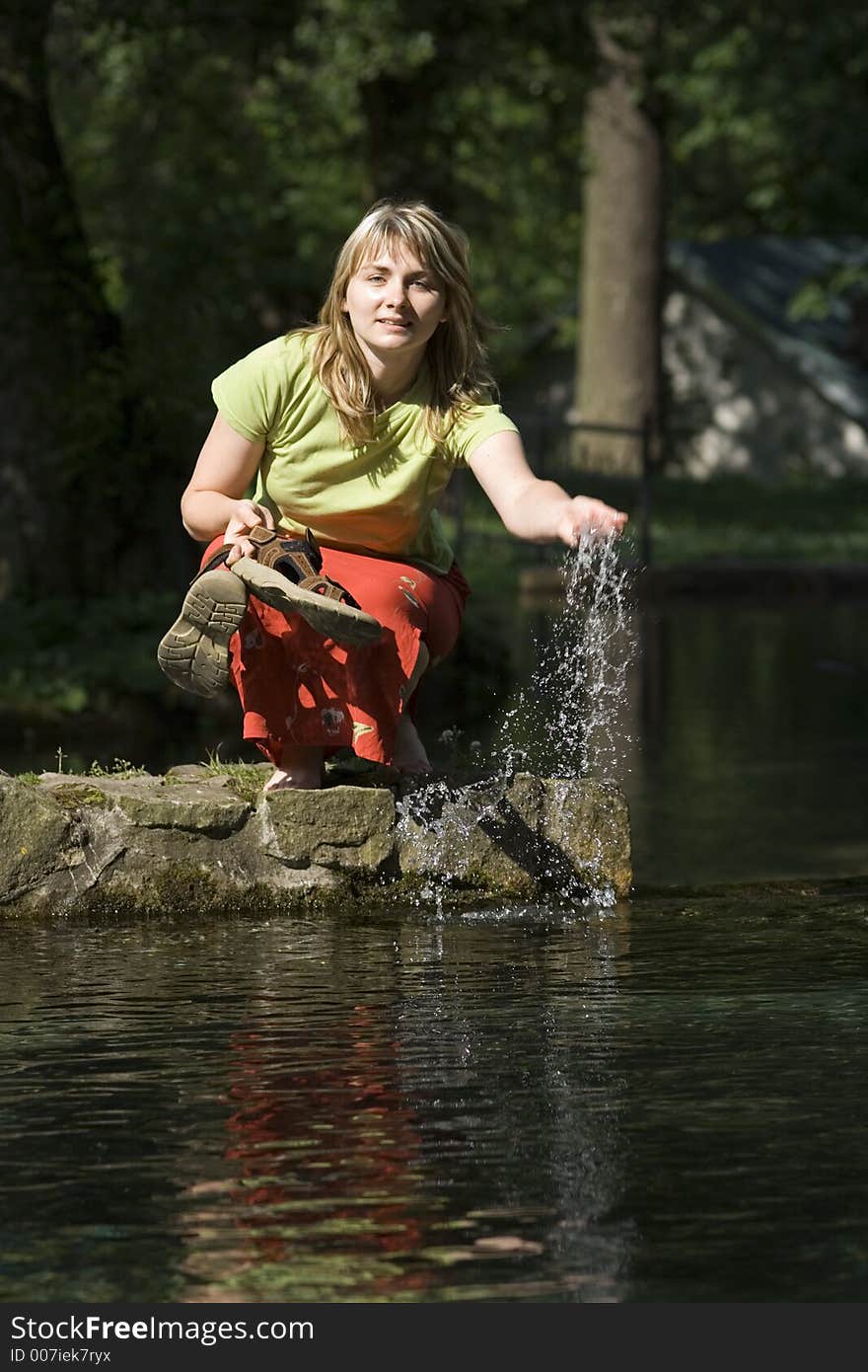 Woman is splashing a water. Woman is splashing a water.