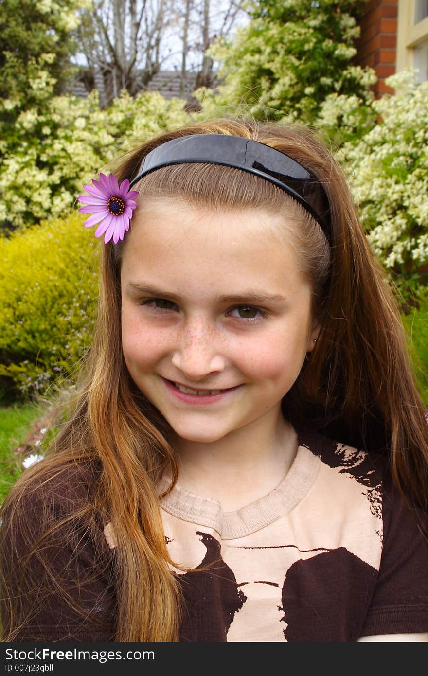 Beautiful young girl with flower in hair. Beautiful young girl with flower in hair