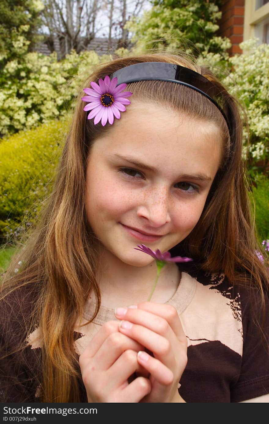 Beautiful young girl with flower in hair. Beautiful young girl with flower in hair