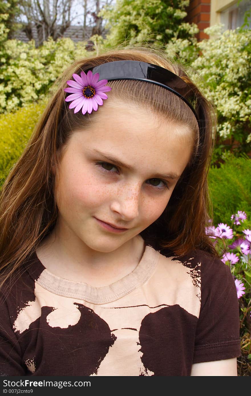 Beautiful young girl with flower in hair. Beautiful young girl with flower in hair