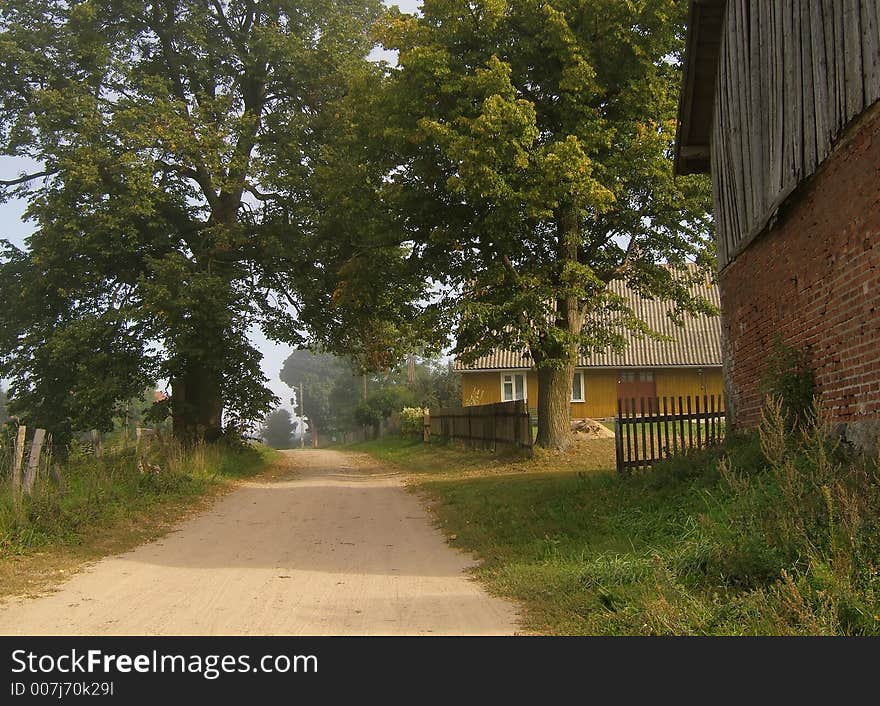 Farm road with old buildings. Farm road with old buildings