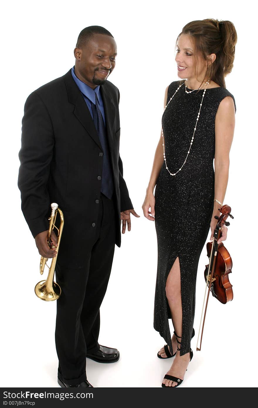 Two musicians, a woman on violin and a man on trumpet, playing around backstage holding their instruments before a concert. Two musicians, a woman on violin and a man on trumpet, playing around backstage holding their instruments before a concert.