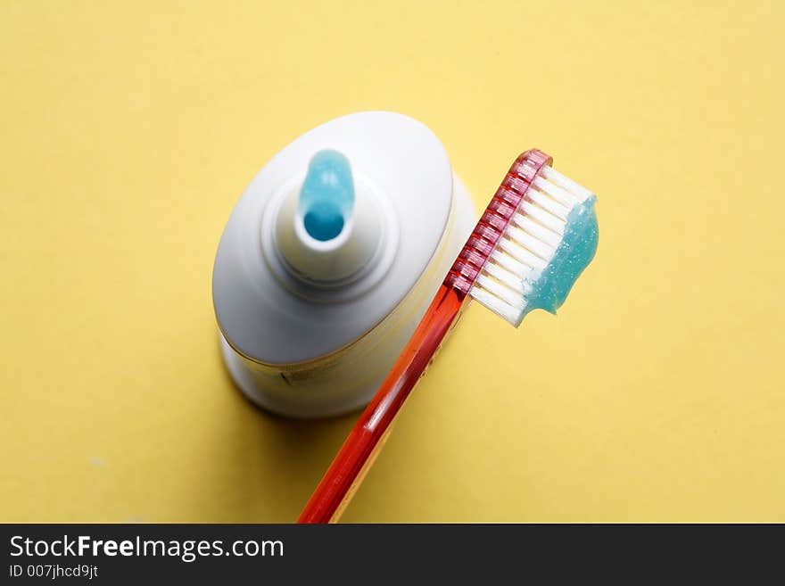 Red Toothbrush With Tube of Toothpaste