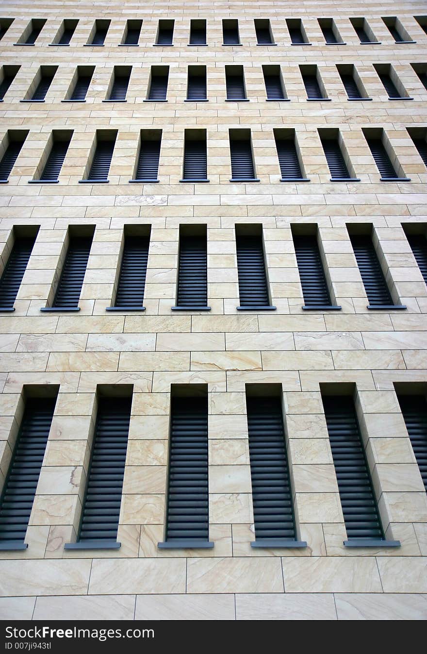 Facade of a modern business building with lots of thin windows. Facade of a modern business building with lots of thin windows.