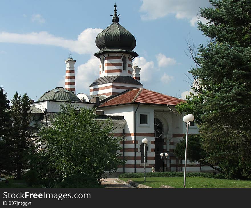 Beautiful old church in the bulgarian town of pleven on blue sky with white clouds