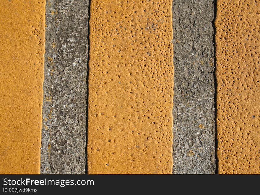 An abstract series with yellow paint on the grey pavement. An abstract series with yellow paint on the grey pavement