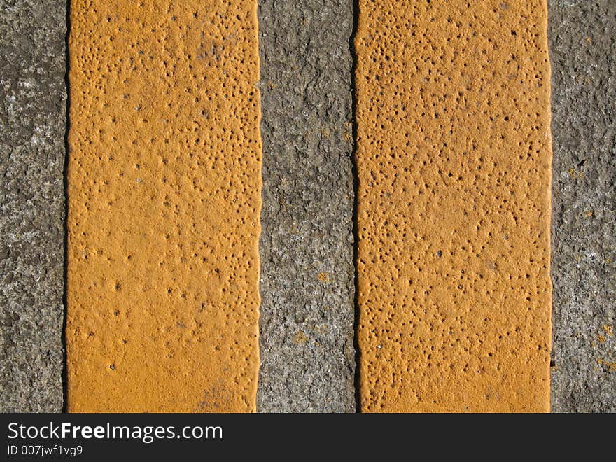 An abstract series with yellow paint on the grey pavement. An abstract series with yellow paint on the grey pavement