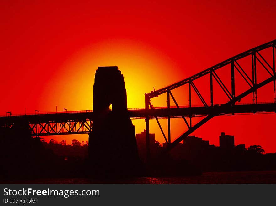 Silhouette of a bridge in the rising sun