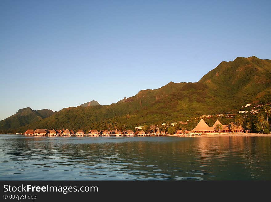 Tropical ressort at sunrise, with overwater bungalows