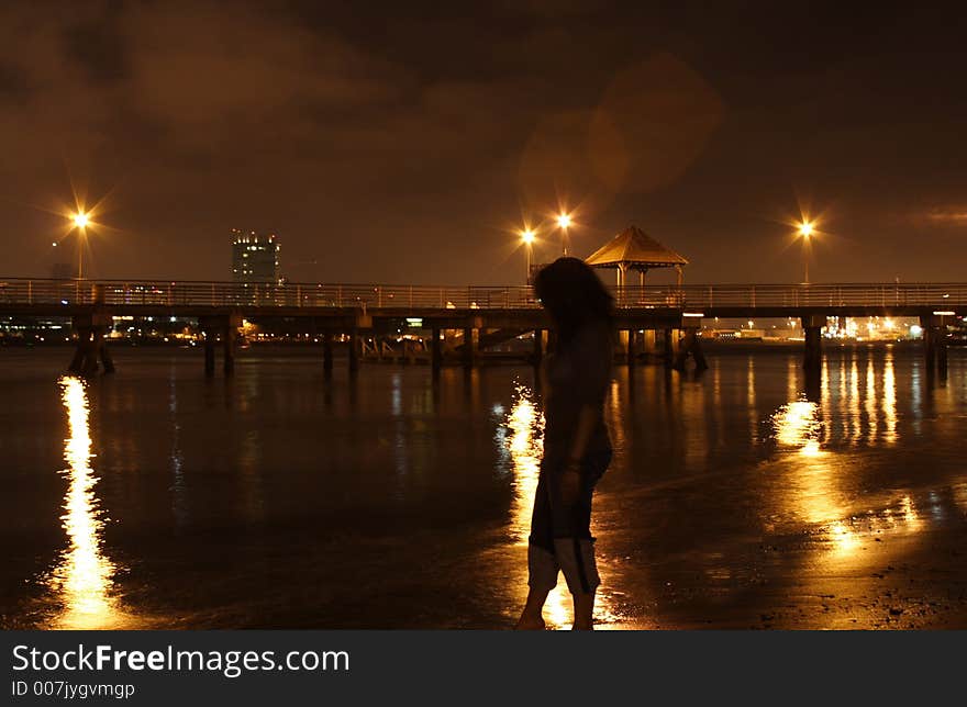 A woman's outline against a night scene. A woman's outline against a night scene