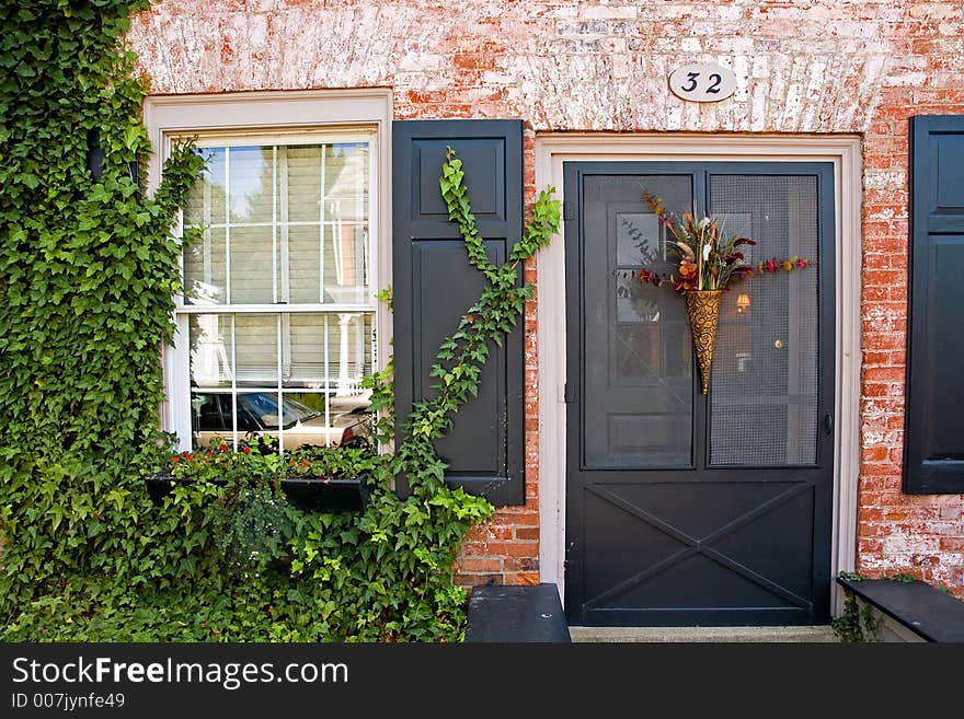 Main entrance and door to an old brick house in a small, rural community. Main entrance and door to an old brick house in a small, rural community.