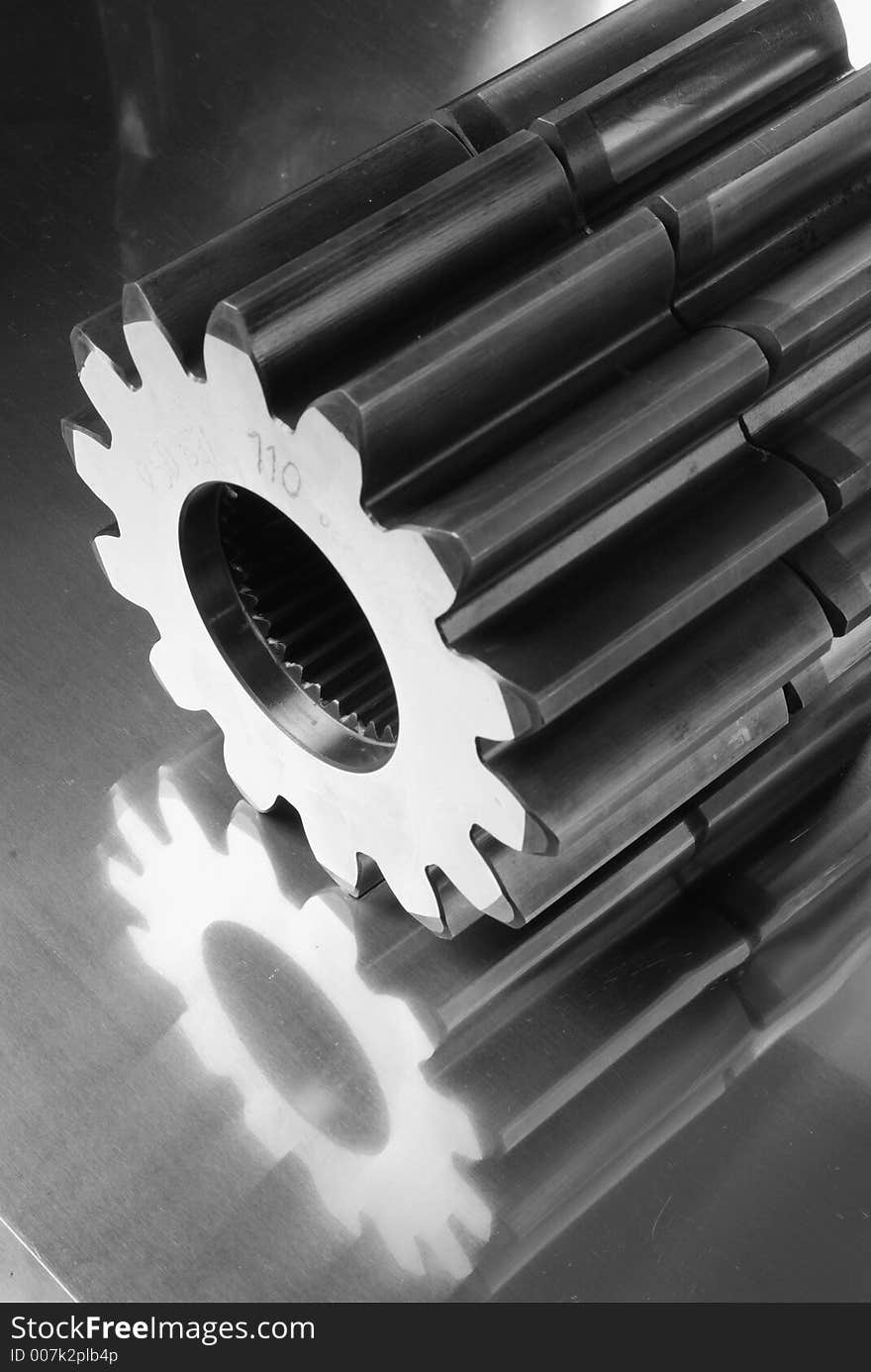 Gears reflecting in titanium in a luminous way, in black/white. Gears reflecting in titanium in a luminous way, in black/white