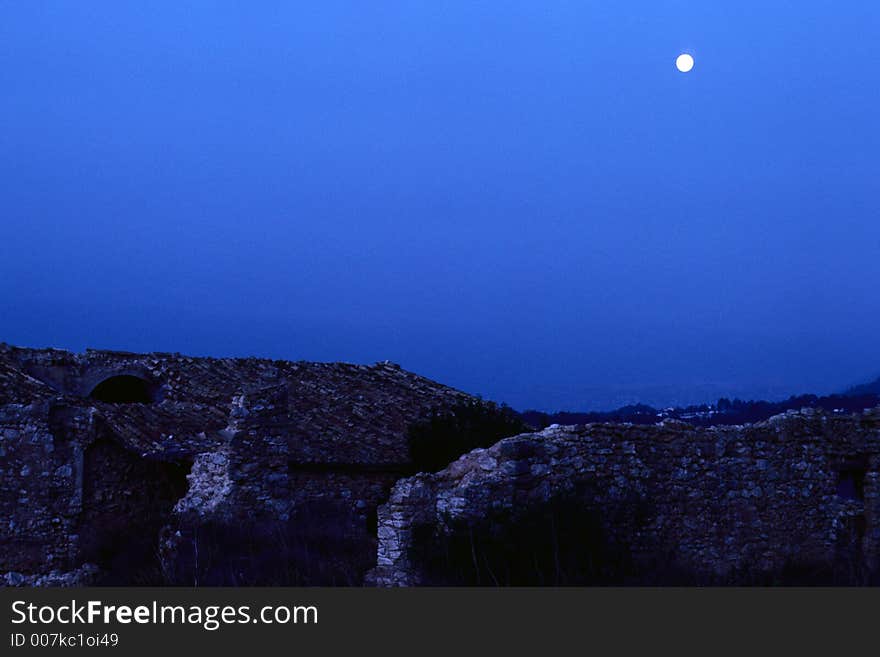 Ruin of an old finca in the south of spain. Lightened by the moon, the dawning sky und the first light of sun in a mixture of blue, pink and pale white light. Ruin of an old finca in the south of spain. Lightened by the moon, the dawning sky und the first light of sun in a mixture of blue, pink and pale white light.