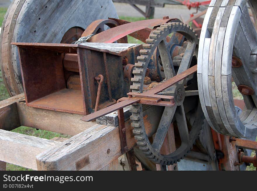 Photo of antique machine showing the gears and moving parts.