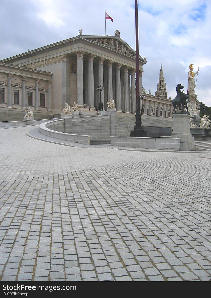 The architect Theohil Hansen chose a strict Neo-Clasical style when he designed the immense Parliament building. The parliament building was originally constructed as part of the Ringstrasse development to act as the Reichsrat building (the Parliament of the Austrian part of the Habsburg empire). Construction began in 1874 and finished in 1884. The front is guarded by the bronze Horse Tamers (1901. The architect Theohil Hansen chose a strict Neo-Clasical style when he designed the immense Parliament building. The parliament building was originally constructed as part of the Ringstrasse development to act as the Reichsrat building (the Parliament of the Austrian part of the Habsburg empire). Construction began in 1874 and finished in 1884. The front is guarded by the bronze Horse Tamers (1901