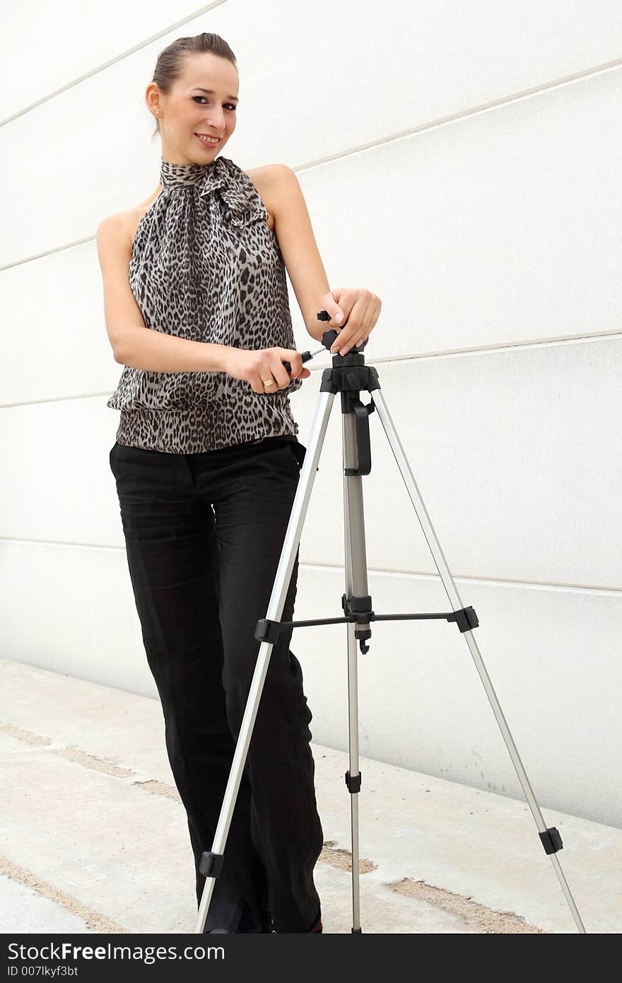 A Model presenting a tripod. A Model presenting a tripod