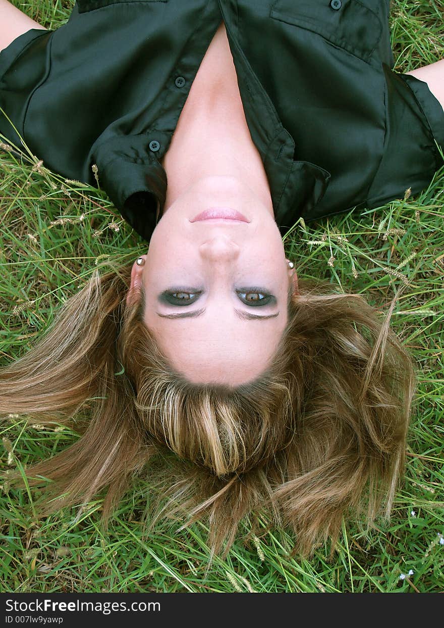 Woman lying in a green field. Woman lying in a green field