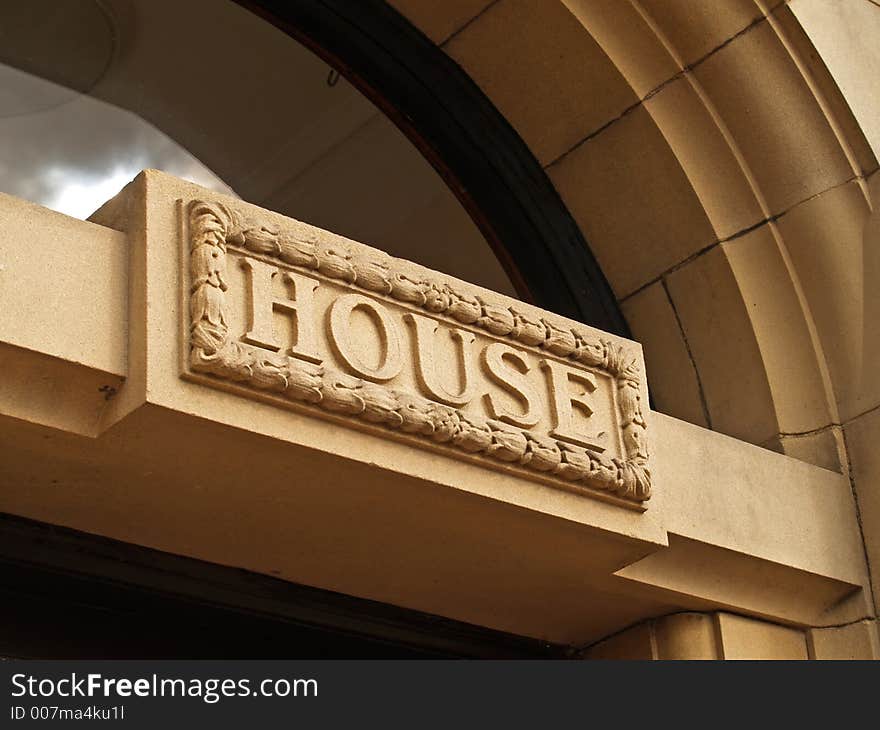 Carved stone house sign above a door