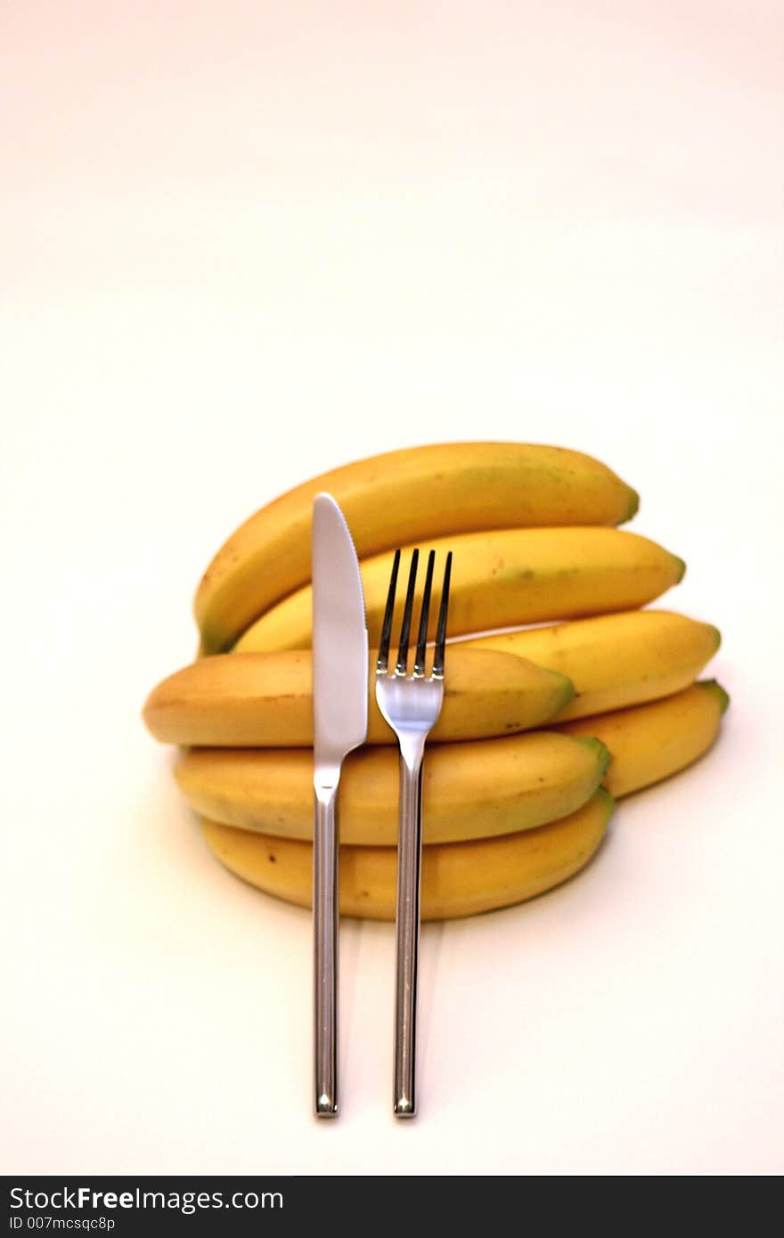 Bananas with a fork and a knife, A natural dessert. Bananas with a fork and a knife, A natural dessert