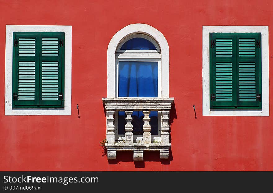 Green and red building at the sea shore. Green and red building at the sea shore