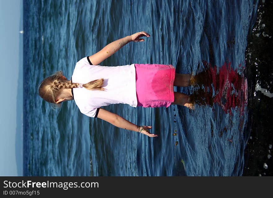 Young Girl Playing in Pacific Ocean. Young Girl Playing in Pacific Ocean